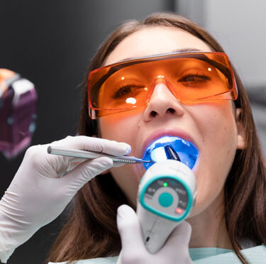 Girl seating at Concord periodontics during Laser treatment
